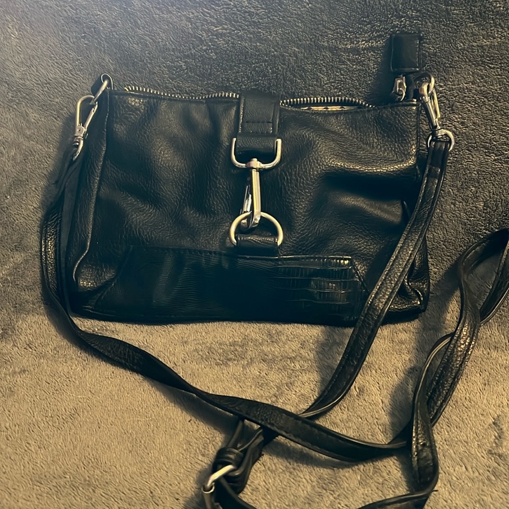 Crossbody purse. 3 inside pockets. 10” wide 6.5” tall. Ziptop with magnetic snap